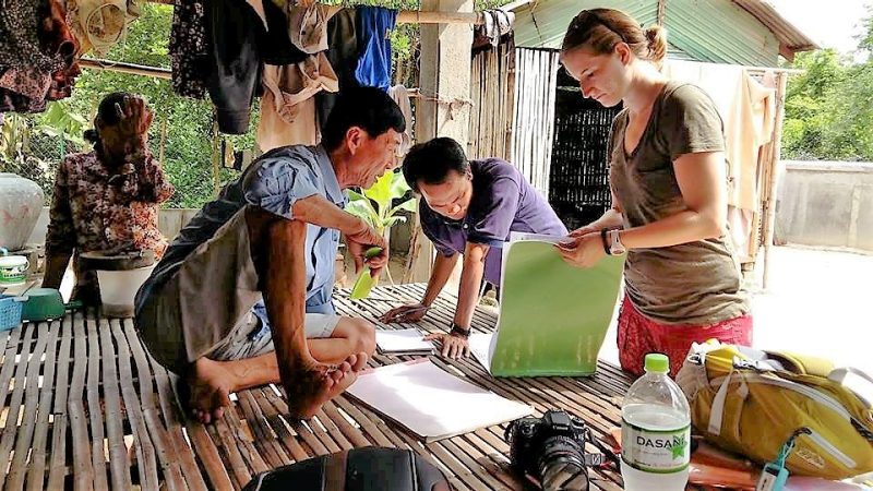 Sydni Jackson gathering survey responses from Cambodian farmers.