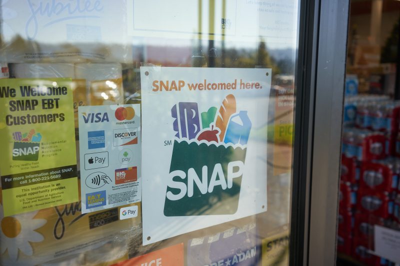 SNAP benefits sign on store door.