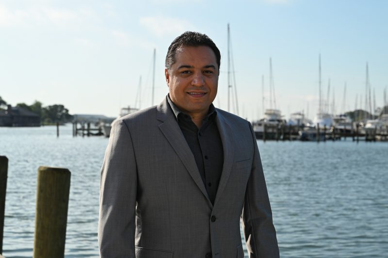 Headshot of Jonathan van Senten, standing in front of marina. 